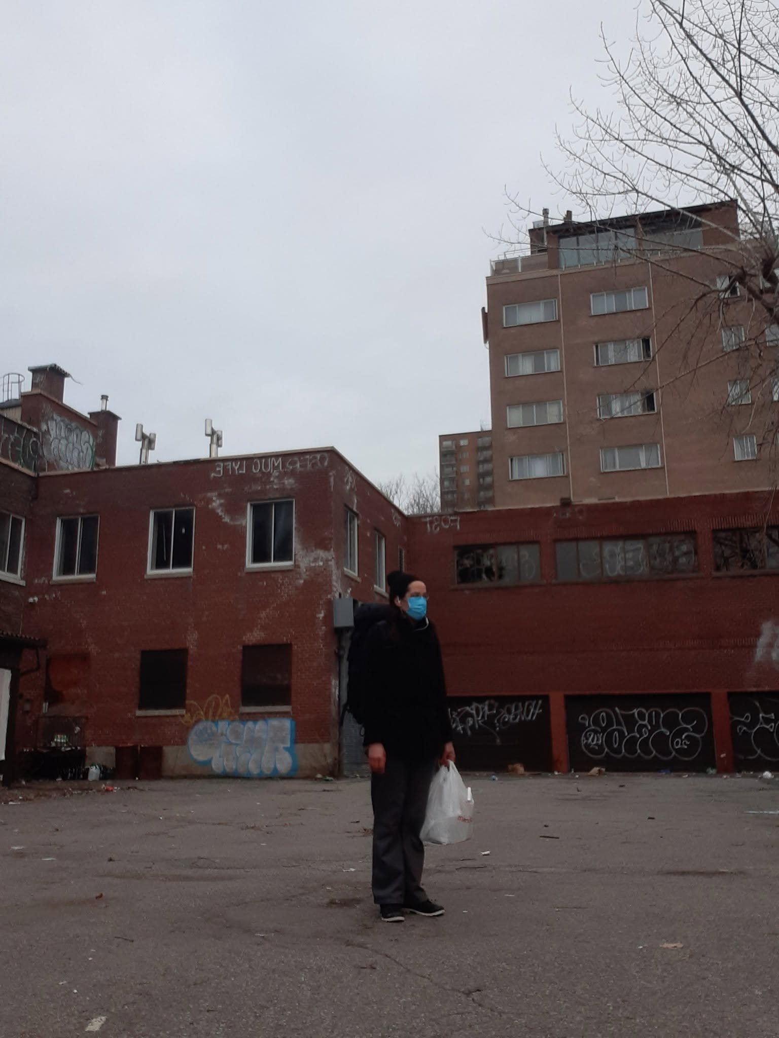 person standing alone in an empty lot